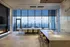 Luxurious modern dining area with panoramic city views, stylish lighting, and elegant fireplace.