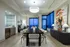 Sophisticated dining area with plush seating, modern art, and panoramic city views through floor-to-ceiling windows.