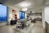 Luxurious open-plan dining and kitchen area featuring elegant wood flooring, modern cabinetry, and stunning city views.