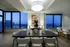 Sophisticated dining area with panoramic city views, elegant decor, and cozy seating for a luxurious apartment experience.