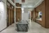 Elegant modern dining area featuring a sleek marble table, designer lighting, and rich wooden accents, perfect for entertaining in style.