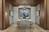 Elegant dining area with contemporary design featuring wooden paneling, a stylish pendant light, and modern artwork.