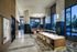 Sophisticated apartment lobby featuring elegant lighting, modern seating, and floor-to-ceiling windows with a serene view.