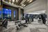 Modern gym facility with state-of-the-art fitness equipment, sleek design, and large windows for natural light.