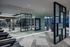 Modern gym space with state-of-the-art equipment, sleek mirrored walls, and stylish geometric decor.
