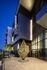 Elegant exterior view of Hanover Burlingame with modern architecture and intricate golden sculpture, illuminated at dusk.