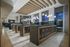 Elegant apartment lobby with modern chandeliers, stylish mailboxes, and large windows showcasing a stunning evening view.