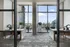 Modern high-rise common area with panoramic city views, elegant marble tables, and stylish decor.