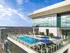 Luxurious rooftop pool with stunning city views and modern terrace seating, perfect for relaxation.