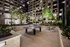 Elegant urban courtyard with modern amenities including table tennis under ambient string lights, surrounded by lush greenery and contemporary architecture.