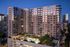 Modern high-rise apartment complex at dusk featuring stunning city views, illuminated windows, and an inviting outdoor pool area.