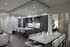Contemporary apartment kitchen and dining area featuring sleek dark cabinetry, a large center island with plush stools, and a stylish dining table set for elegant gatherings.