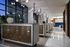 Sleek apartment lobby with modern mailbox setup, glossy floors, and elegant lighting fixtures.