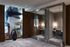 Elegant lobby area with modern artistic wall design, glass partitions, and a cozy workspace with stylish lighting.