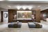 Luxurious apartment lobby with elegant chandeliers, modern seating, and a stunning abstract wall art centerpiece at Hanover Post Oak.