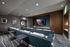 Luxurious home theater with plush seating, modern art, and sleek design, perfect for cinematic experiences.