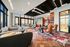 Luxurious open-concept living space with elegant seating, floor-to-ceiling windows, and cityscape views.