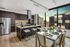Luxurious modern kitchen and dining area with high-end appliances, sleek island seating, and stunning city skyline views through expansive windows.