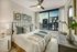 Chic urban bedroom with a stunning city view, featuring elegant decor, cozy bed, and modern furnishings.