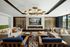 Sophisticated living room with modern decor, featuring elegant couches, a stylish chandelier, and a contemporary fireplace, perfect for relaxation.