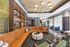 Elegant contemporary lounge with a plush orange sectional sofa, stylish shelving, and modern lighting, creating a cozy ambiance.