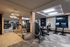 Modern gym with sleek exercise equipment, stylish lighting, and large windows for a bright workout atmosphere.