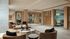 Luxurious apartment lobby featuring elegant seating, stylish decor, and modern wooden paneling.