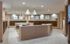 Elegant lobby mailroom with modern lighting, warm wood tones, and sleek mailbox design for a sophisticated apartment experience.