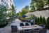 Chic outdoor patio with elegant seating, fire pit, and lush greenery creates a serene retreat at a modern apartment complex.