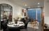 Chic and modern living room featuring a cozy sectional sofa, elegant dining area, and large windows with stylish blinds.