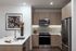 Sleek modern kitchen with stylish wood cabinetry, stainless steel appliances, and an elegant white countertop, perfect for entertaining.