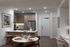Elegant open-concept kitchen with modern wood cabinetry, stainless steel appliances, and a cozy dining area, ideal for entertaining.