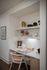Elegant home office nook with built-in shelves, stylish decor, and a sleek desk setup.