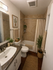 Chic and inviting bathroom with elegant tile walls, modern fixtures, and lush greenery accents.