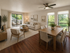 Bright and inviting living-dining area featuring modern furniture, large windows with lush outdoor views, and elegant wooden flooring.