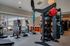 Modern apartment fitness center equipped with treadmills, benches, punching bag, and exercise equipment.