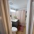 Elegant bathroom with modern vanity, decorative lighting, and stylish shower curtain.