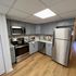 Stylish modern kitchen featuring stainless steel appliances, sleek cabinetry, and a marble backsplash.