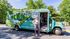 Bright and inviting shuttle bus for The Den Student Living with vibrant nature-themed design.