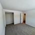 Bright and airy bedroom featuring a walk-in closet and plush carpeting, perfect for relaxation.