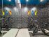 Modern exercise room with stationary bikes and vibrant patterned walls.