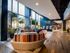 Stylish lobby featuring modern seating, large windows, and sleek wood flooring with contemporary decor.