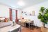 Bright, inviting bedroom with twin beds, plaid bedding, and stylish decor.