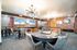 Elegant recreation room featuring stylish card tables, modern lighting fixtures, and cozy seating.