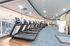 Contemporary gym with state-of-the-art treadmills and large glass windows offering a scenic view.