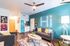Chic and colorful living room featuring modern furniture, vibrant wall art, and cozy lighting.
