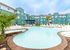 Inviting resort-style pool surrounded by modern apartments and lush greenery.