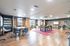 Stylish open-plan workspace with modern furniture, vibrant decor, and abundant natural light.