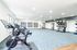 Bright and modern fitness studio featuring high-end exercise bikes and organized equipment racks.