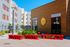 Charming entrance of River Trail Village with modern architecture and colorful facade, promising vibrant community living.